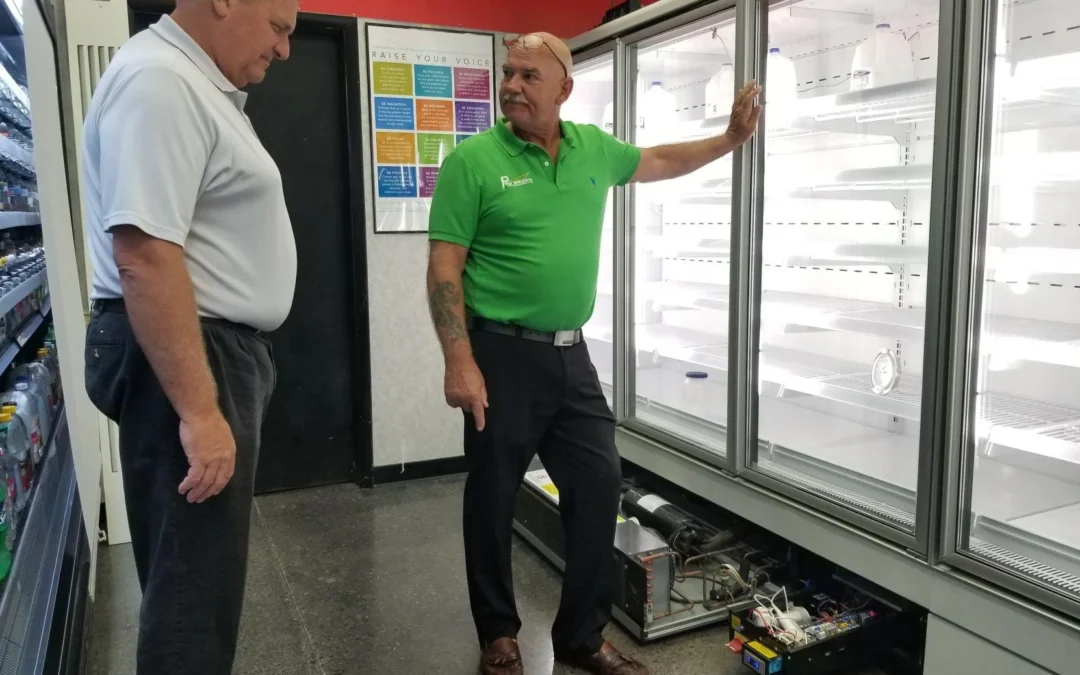 2 men looking at purecold commercial refrigeration